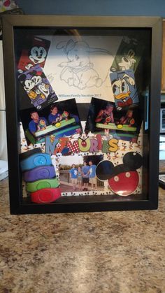 mickey mouse magnets are in a shadow box