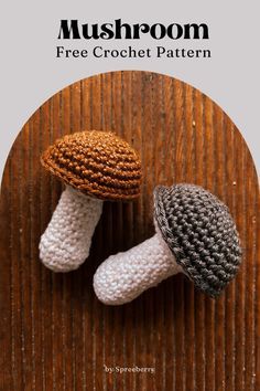 two crocheted mushrooms sitting on top of a wooden table