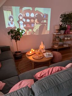 a living room filled with furniture and a projector screen