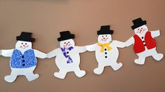 four snowmen are hanging on the wall