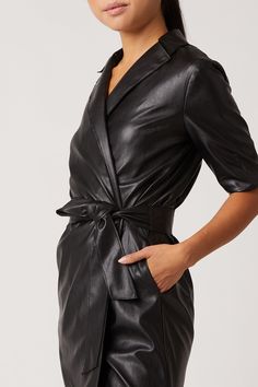 Our Robin Vegan Leather Dress, is a sultry trench dress that signifies everything chic. This bold black mini has 3/4 length sleeve detail, is made of our Vegan Leather with Japanese Technology, and hits above the knee in length. 100% Vegan Leather - 100% Polyurethane Dry Clean Only Made in USA Model is 5'11 and wearing size S Sleek Black Blazer Dress For Office, Sleek Black Blazer Dress For Work, Sleek Black Office Blazer Dress, Black Belted Blazer Dress For Work, Belted Knee-length Mini Dress For Work, Belted Midi Mini Dress For Work, Belted Mini Dress For Workwear With Midi Length, Fall Knee-length Blazer Dress For Night Out, Knee-length Belted Mini Dress For Work