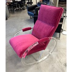 a pink chair sitting on top of a metal frame