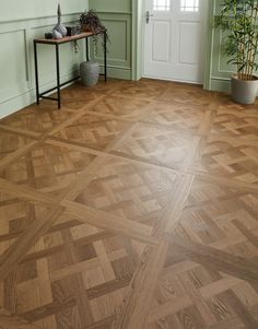 a wooden floor in a room with green walls and wood parquets on the floor