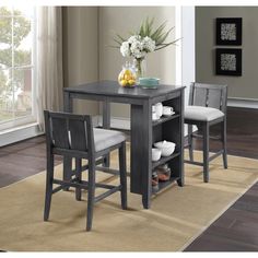 a kitchen table with two chairs and a shelf for plates, bowls, and cups