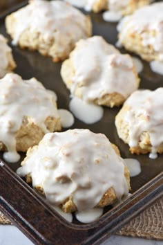 there are some cookies with icing on top of them in the baking pan, ready to go into the oven