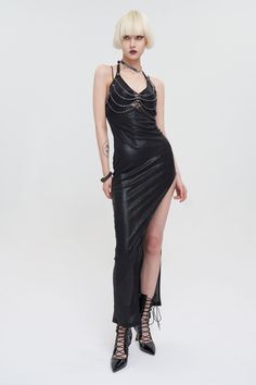 Harnessed Power Dress A stunning, must-have maxi black dress in a faux leather finish with built-in harness chains, halter-tie back and deep leg split. The chest piece features chrome spikes and rings which connect the horizontal chains. This skintight, wet-look femme fatale piece has everything you need for a goth club night out - just pair with heels and go! Material: Polyester/Spandex/Synthetic Leather. Size XS-S M-L XL-2XL 3XL-4XL Bust 26.8"/68cm 30.7"/78cm 34.6"/88cm 38.6"/98cm Waist 24.8"/ Maxi Black Dress, Goth Club, Power Dress, Dress Display, Hot Poses, Leg Split, Chest Piece, Goth Dress, Sleeveless Long Dress