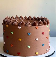 a cake with chocolate frosting and hearts on it