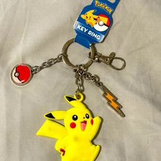 a pokemon pikachu keychain is shown on a white sheet