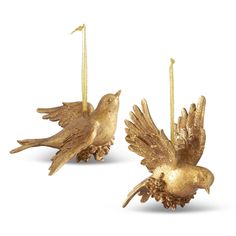 two gold colored birds hanging from strings on white background, one has its wings open and the other is upside down