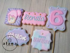 decorated cookies are arranged in the shape of signs