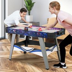 two people playing a game on an interactive table