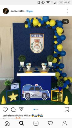 a police car themed dessert table with balloons and decorations on the top, along with an officer's cake stand