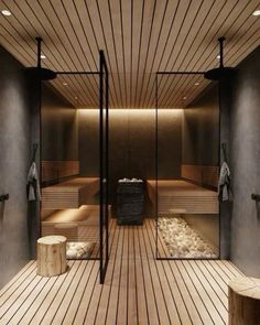 an indoor sauna with wooden floors and benches