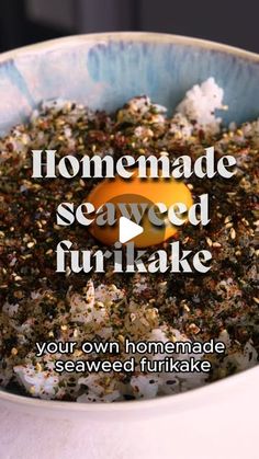 a bowl filled with seaweed and flakes on top of a white tablecloth