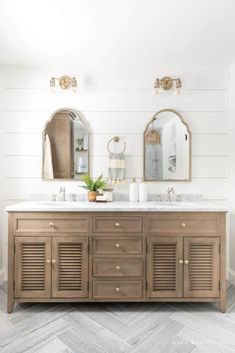 a bathroom with two sinks and mirrors on the wall next to each other in front of white shiping