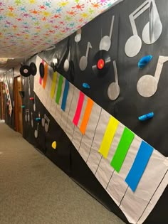 an office hallway decorated with musical instruments and music notes on the wall, along with colorful streamers