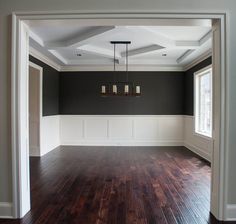 an empty living room with hard wood flooring and white trim on the walls is shown