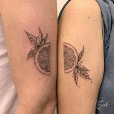 two people with matching tattoos on their arms, one has a slice of orange and the other has a leaf