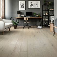 a home office with wood floors and gray walls