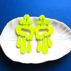 These earrings are painted with specialty paint in neon yellow.  Close up the color is glittery and very bright. These earrings are almost 3 inches long in total and are 1.25 inch wide at the the widest point. All pieces of this earring are handmade by me in my studio. Each earring weighs less than a quarter ounce, they are super light. I make the art, I cut it out, I seal it and finish it. This process takes like a week and sometimes it just doesn't work out, sealing is tricky! I love each piece that turns out and the color and beauty always amazes me! Please note that these earrings are made to order and could/will take 4-5 days to ship! Each piece of jewelry made by me is a special piece of art, a representation of where I'm at in the artistic journey of life.  The process to make these Neon Yellow Earrings, Bold Green Earrings For Gifts, Bold Green Earrings For Gift, Yellow Fun Earrings For Party, Vibrant Green Dangle Earrings, Bold Yellow Drop Earrings, Fun Yellow Hand Painted Earrings, Fun Hand Painted Yellow Earrings, Green Resin Fun Earrings