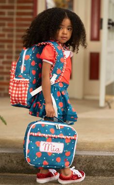 Get ready for school with our Apples on Navy Ruffle Backpack! This cute and sweet backpack is perfect for all your school needs. The ruffle detailing adds a fun touch to your everyday look. Don't be afraid to show off your playful side with our quirky and unique bag! Large exterior pocket 2 exterior side pockets Large inside pocket Full size: 16 x 13 x 3.5 Care Instructions: Spot Clean Hand Wash Lay flat to dry "Transport your lunch in style with this playful Apples on Navy Ruffle Lunch Bag! Per Preppy Bags For School Season, Preppy Bags For Students At End Of School Year, Preppy Student Bags For End Of School Year, Playful Red School Bag, Red Backpack For School Events, Cute Red Backpack For School, Red Bags For School And End Of School Year, Red Backpack For End Of School Year Events, Cute Red School Backpack