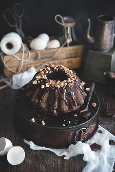 a chocolate bundt cake sitting on top of a wooden table