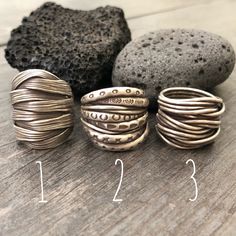 Three unique and powerful statement rings. The 3 of them are made in a braided, overlapping style that creates this unique chunky silver rings. Perfect everyday rings, that will rock your outfits, and are easy to match any other accessories. In one of the pictures, you can see which number represents each ring. Ring 1 is a size 8.5 Ring 2 is a size 8 Ring 3 is a size 8 All unique addition to your ring collection. To see more unique silver rings, click the link below https://www.etsy.com/shop/Aka Handmade Adjustable Wide Band Stackable Rings, Handmade Unique Rings With Thick Band, Unique Handmade Rings With Thick Band, Bohemian Wide Band Ring, Bohemian Hand Wrapped Metal Rings, Handmade Open Ring With Modern Twist, Handmade Open Ring With A Modern Twist, Bohemian Hand Wrapped Open Ring, Bohemian Style Hand Wrapped Open Ring