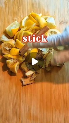 a person chopping fruit on top of a wooden table with the words stick in front of them