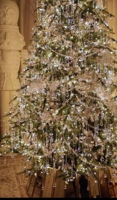 a white christmas tree in the middle of a room