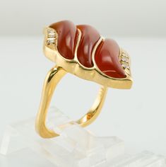 Fire Ring, Flame Ring, Orange Ring, Carnelian Ring, Diamond Ring, Vintage Ring, Gold Ring, Square Band, Gold Band, Cocktail Ring. This one of a kind estate ring is crafted in solid 18K Yellow Gold. The setting with natural Carnelian is reminiscent of flames. Absolutely stunning! Six diamonds total .13 carat of VS1 clarity and H color. The square band is 17mm x 16mm inside, it is hard to know the size. We would say the size is around 7-7.25 and the ring can easily be resized. The top of the ring Yellow Gold Carnelian Wedding Jewelry, Elegant Carnelian Ring In Yellow Gold, Elegant Carnelian Yellow Gold Rings, Anniversary Carnelian Rings With Polished Finish, Elegant Yellow Gold Carnelian Ring, Heirloom Carnelian Yellow Gold Rings, Vintage Carnelian Gemstone Rings, Vintage Carnelian Yellow Gold Ring, Luxury Yellow Gold Carnelian Rings