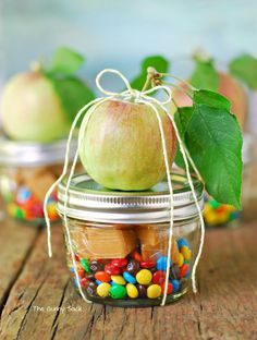 an apple in a jar filled with candy