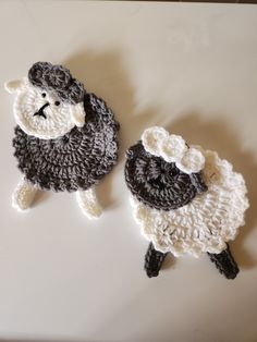 two crocheted sheep sitting next to each other