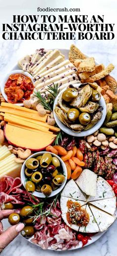 a platter filled with different types of cheeses, olives and crackers