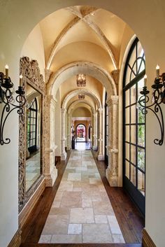 an arched hallway leading to the front door