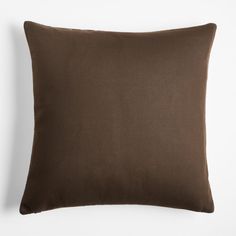 a brown pillow on a white wall