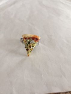 a slice of pizza sitting on top of a piece of paper