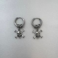 Rock your style with these Skull Dangle Drop Earrings. Perfect for streetwear, punk, and hip hop lovers, these earrings add an edgy touch to any outfit. Made for both men and women, they are the ultimate unisex accessory. Stand out from the crowd and show off your unique fashion sense with these earrings. Earrings length 1.3 inch width 0.7 inch. Streetwear Dangle Pierced Earrings, Punk Style Pierced Earrings For Streetwear, Single Metal Earring For Streetwear, Punk Dangle Earrings For Streetwear, Nickel-free Skull Earrings In Punk Style, Edgy Earrings, Unisex Accessories, Streetwear Women, Unisex Fashion