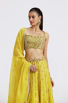 Stylish lemon yellow embellished organza lehenga is perfect for weddings. It comes with a dupatta. Shop online from Pure Elegance. Disclaimer: The actual product may vary slightly from the image. These are custom orders, hence expect slight variation in color and placement of the motif or buta. ESTIMATED DELIVERYBecause this is a custom order, it would take about 4 weeks from the date of purchase. RETURN POLICYThis product is a custom order and cannot be returned or exchanged. Yellow Cutdana Sharara For Reception, Yellow Gota Work Sets For Reception, Yellow Embellished Sharara For Navratri, Yellow Organza Sets With Mirror Work, Yellow Mirror Work Sets For Reception, Yellow Sets With Mirror Work For Reception, Embellished Yellow Sharara For Diwali, Diwali Yellow Embellished Sharara, Embellished Yellow Sets For Reception