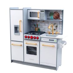 a toy kitchen with white appliances and gold handles on the stove, oven, microwave and sink