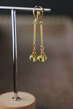 Simple minimalsit earrings with small yellow clear calcite stone 8 mm beads, gold tone stainless steel stick connectors, tiny gold tone stainless steel beads and gold tone stainless steel lever back earrings hooks. Earring hooks are from nickel free and lead free metal. *The total lenght of earrings is about 54 mm including earring hooks. Perfect jewelry for everyday wear or a great gift for someone special! Other earrings of my shop you can see here: https://www.etsy.com/shop/NaTavelli?section_ Minimalist Gold Crystal Earrings With Ear Wire, Minimalist Dangle Crystal Earrings, Minimalist Gold Crystal Earrings, Minimalist Citrine Jewelry, Gold Minimalist Crystal Drop Earrings, Gold Minimalist Crystal Earrings, Minimalist Yellow Earrings For Pierced Ears, Gold Hypoallergenic Minimalist Crystal Earrings, Citrine Dangle Earrings For Pierced Ears