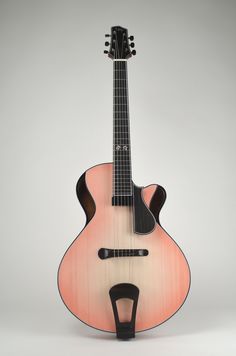 an acoustic guitar is shown with its neck and body in the shape of a guitar