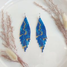 Exquisite and charming, these long beaded earrings feature a sophisticated blue marble design. Handcrafted with meticulous attention to detail, they exude a timeless elegance. Perfect for adding a touch of refinement to any ensemble, these earrings are sure to become a cherished addition to your jewelry collection. Dimensions: - Length: 10 cm (3.9 inches) - Width: 3 cm (1.2 inches) Elegant Light Blue Beaded Dangle Earrings, Elegant Turquoise Chandelier Earrings With Round Beads, Elegant Turquoise Chandelier Earrings, Elegant Light Blue Beaded Drop Earrings, Bohemian Blue Earrings With Polished Beads, Blue Bohemian Earrings With Polished Beads, Elegant Light Blue Beaded Earrings, Elegant Blue Earrings With Colorful Beads, Blue Beaded Chain Dangle Earrings