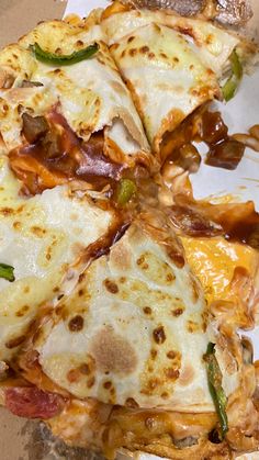 several slices of pizza sitting on top of a white paper wrapper in a box