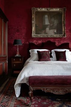 a large bed sitting under a painting in a bedroom