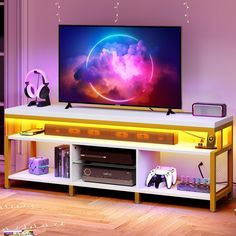 a flat screen tv sitting on top of a white entertainment center