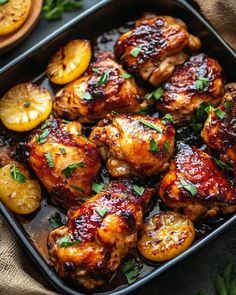 chicken wings with oranges and herbs in a pan