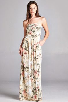 It's not your Grandma's 'antique roses' type of floral dress! This pretty ivory maxi dress features an antique china floral pattern of cream, blush and olive. The perfect romantic date night dress features a strapless neckline, empire waist and practical side pockets. Estimated 2-4 business days for shipping. Available in ivory/blush Made in the USA 96% polyester and 4% spandex Feminine Cream Dress For Garden Party, Fitted Bodice Rose Print Dress For Garden Party, Garden Party Dress With Rose Print And Fitted Bodice, Feminine Cream Maxi Dress With Floral Print, Feminine Cream Floral Print Maxi Dress, Cream Elegant Maxi Dress For Garden Party, Elegant Cream Maxi Dress For Garden Party, Elegant Rose Print Maxi Dress For Garden Party, Cream Floral Print Maxi Dress