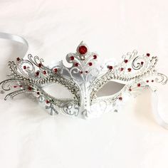 This mask captures the spirit of the clever and graceful fox, making it an ideal choice for those who appreciate its symbolism. Designed for hours of wear, it ensures you can enjoy the festivities in style and comfort. Adorned with rhinestones, this mask sparkles in the light, ensuring you'll shine bright at any masquerade ball, themed party, gala, and other events! Age Group/Gender - Adult/Women Size/Type - One size fits all adults Mask Color - White/Silver Mask Material - Polyresin/Laser cut m Elegant Red Masks For Carnival, Adjustable Masquerade Mask For Carnival Gift, Elegant Red Masquerade Mask For Party, White Eye Mask Masquerade Mask As Gift, Elegant Halloween Masks As Gifts, Fantasy Style Eye Mask For Masquerade, Red Eye Mask As Gift, Red Eye Mask As A Gift, Red Eye Mask For Gift