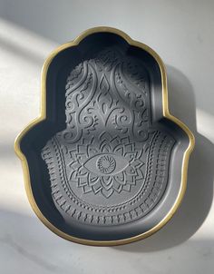 an intricately designed tray is shown against a white wall