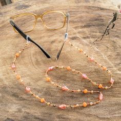 Keep those glasses handy and accessorize at the same time with this pretty eyeglass lanyard. Mirian Zet in Guatemala crafts the lanyard by hand with glistening glass and crystal beads in orange bronze gold and peach hues. Handmade Bohemian Adjustable Glasses Chains, Guatemala Crafts, Orange Czech Glass Beaded Necklace, Brown Handmade Adjustable Glasses Chains, Handmade Orange Glass Necklace, Orange Bohemian Hand-strung Beaded Necklace, Orange Glasses, Glasses Strap, Buy Bead